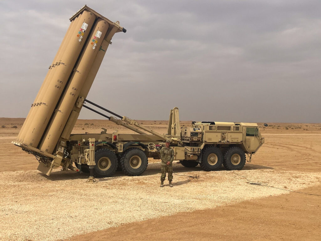 U.S. Army soldier in front of a THAAD launcher ready to counter ballistic missile threats in the CENTCOM region.