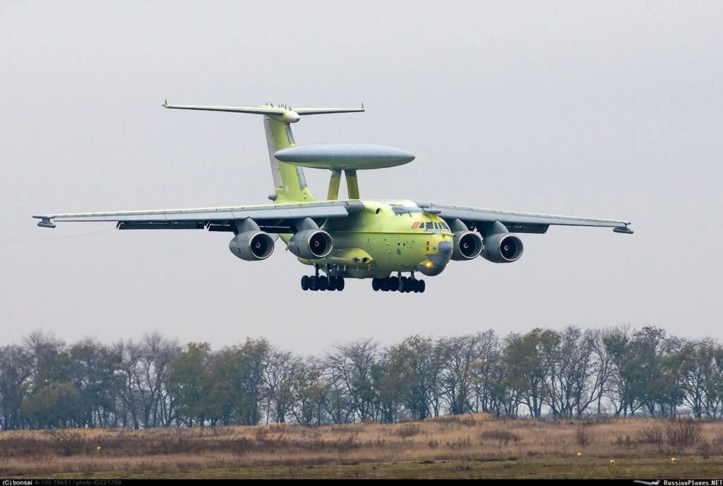 Russian Beriev A-100 AEW&C aircraft in flight, showing the large, rotating AESA radar dome (rotodome) on the fuselage.