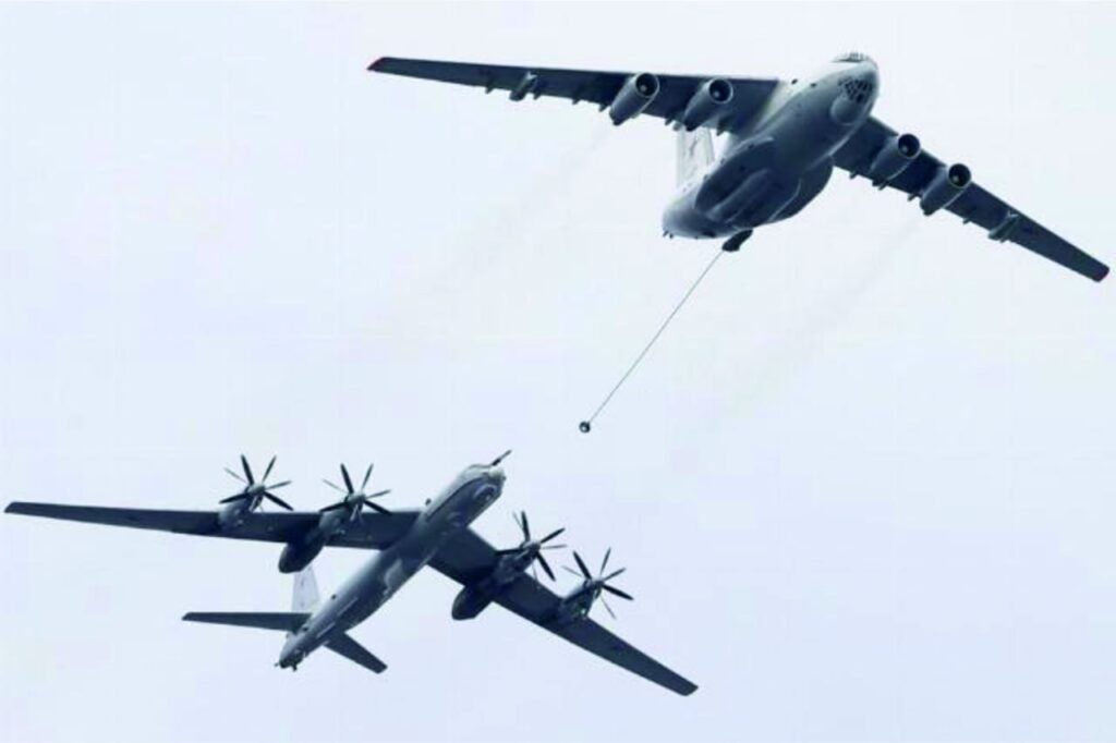 Russian Tu-142K long-range maritime patrol aircraft conducting aerial refueling over the Arctic region.