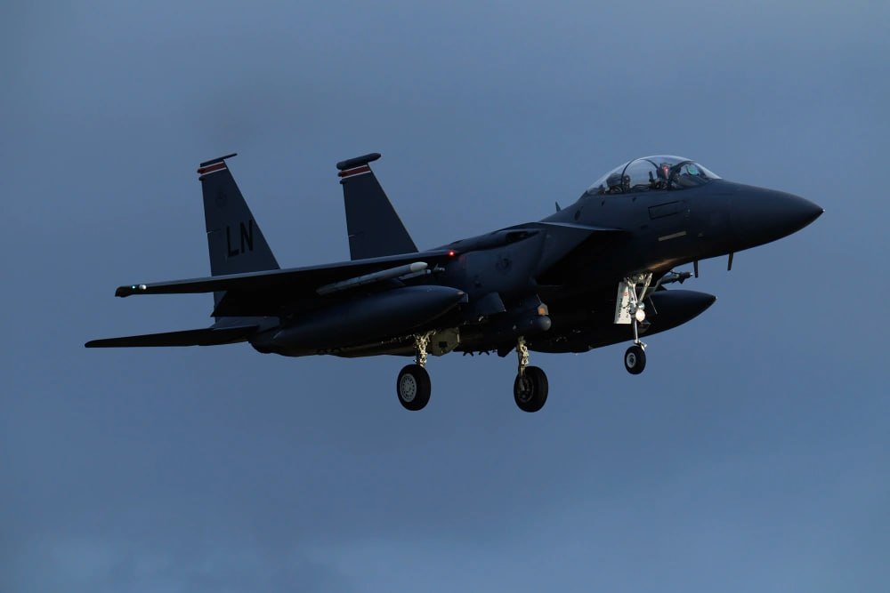 United States Air Force F-15E Strike Eagle fighter jet flying in clear sky during operational mission